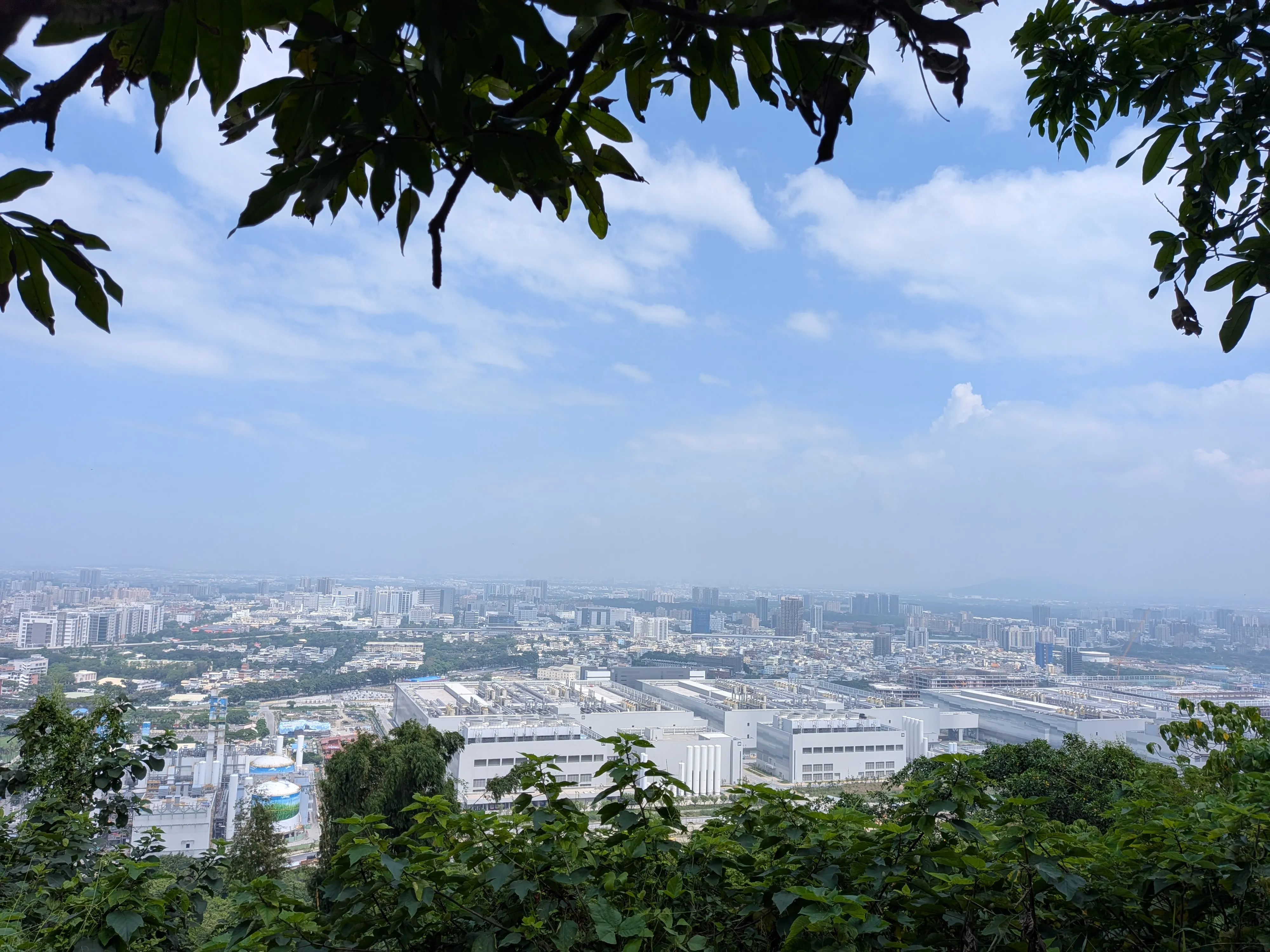 View east from the Banping Mountain ridge over Kaohsiung, with a large white semiconductor fab in the middle distance