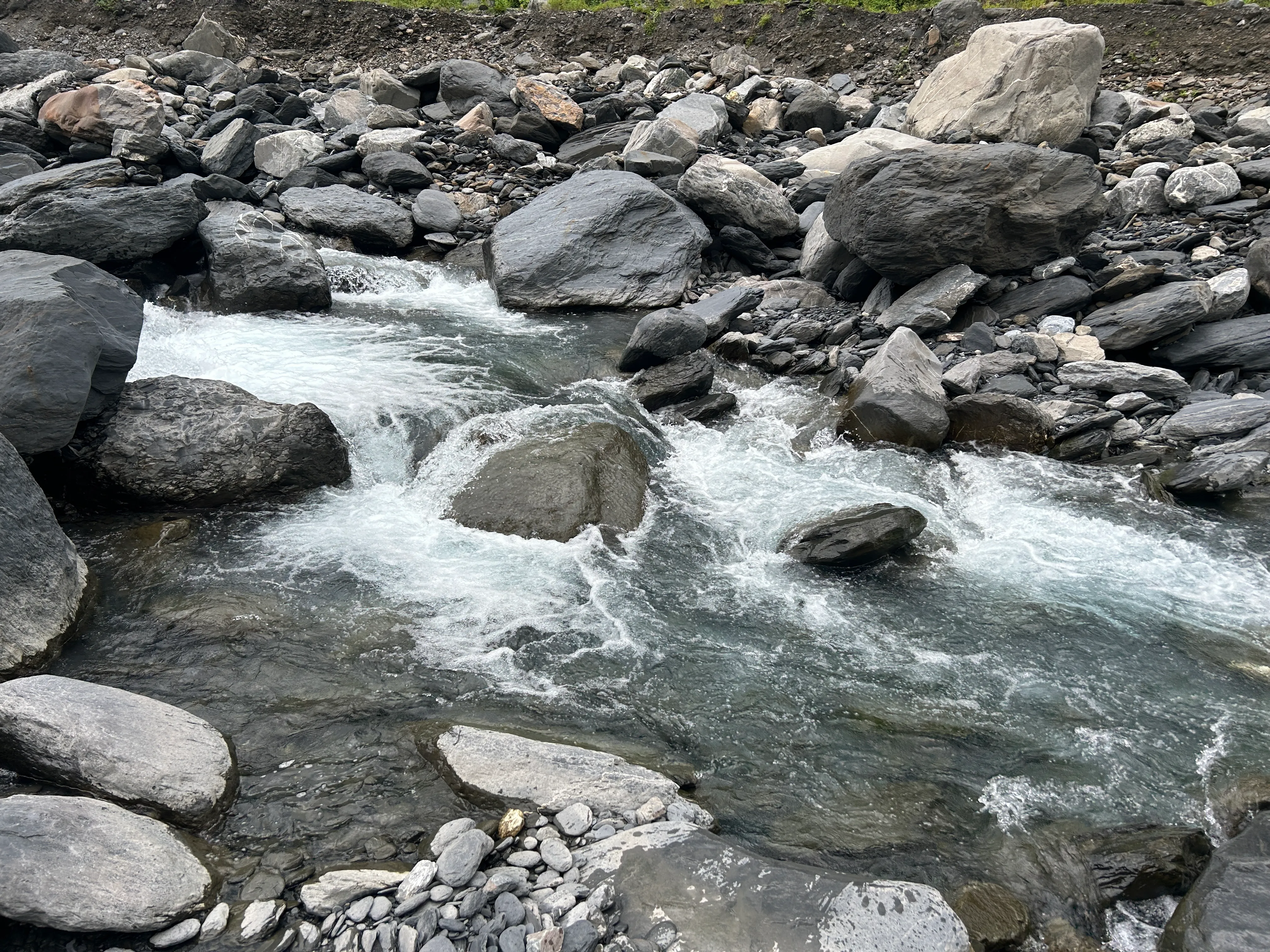 White water rushing between grey riverstones in Walusi River